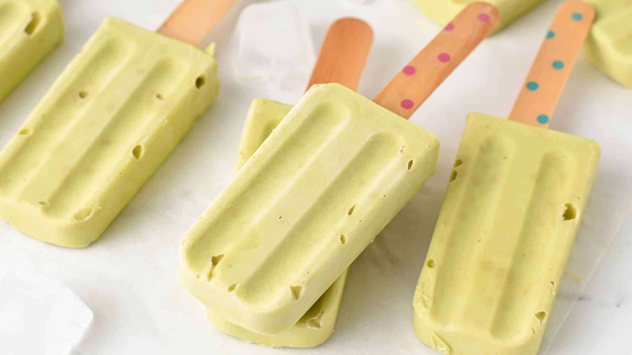 a stack of Avocado Popsicles with a wooden stick