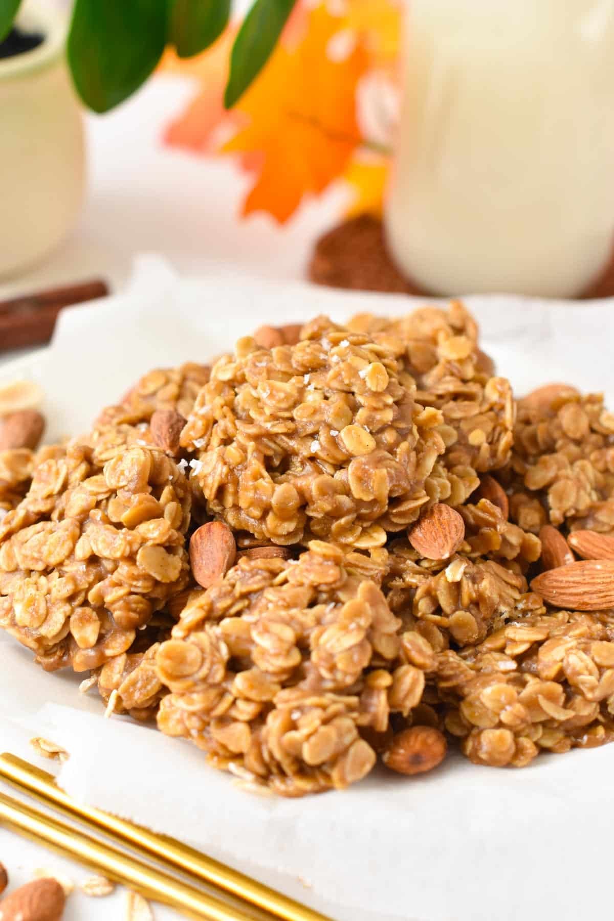 A plate filled with a stack of no-bake oatmeal almond butter cookies.
