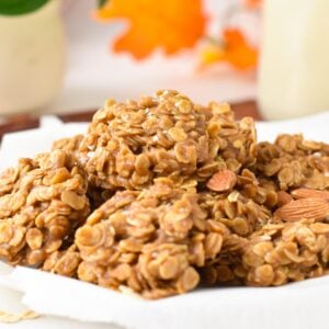 a plate filled with a stack of no-bake almond butter cookies