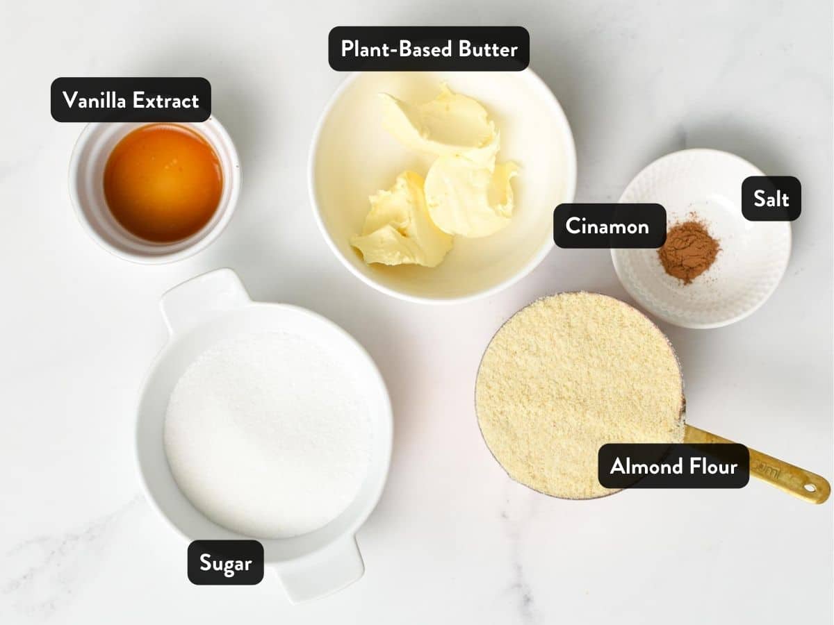 Ingredients for Almond Flour Sugar Cookies in various bowls and ramekins with labels.