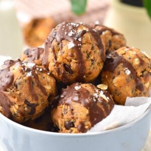 a stack of no-bake peanut butter protein balls filled with chia seeds, oats and flaxmeal