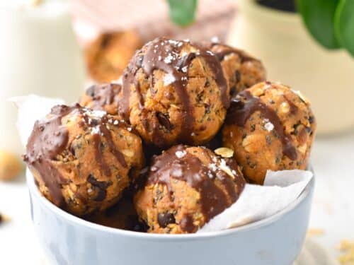 a stack of no-bake peanut butter protein balls filled with chia seeds, oats and flaxmeal