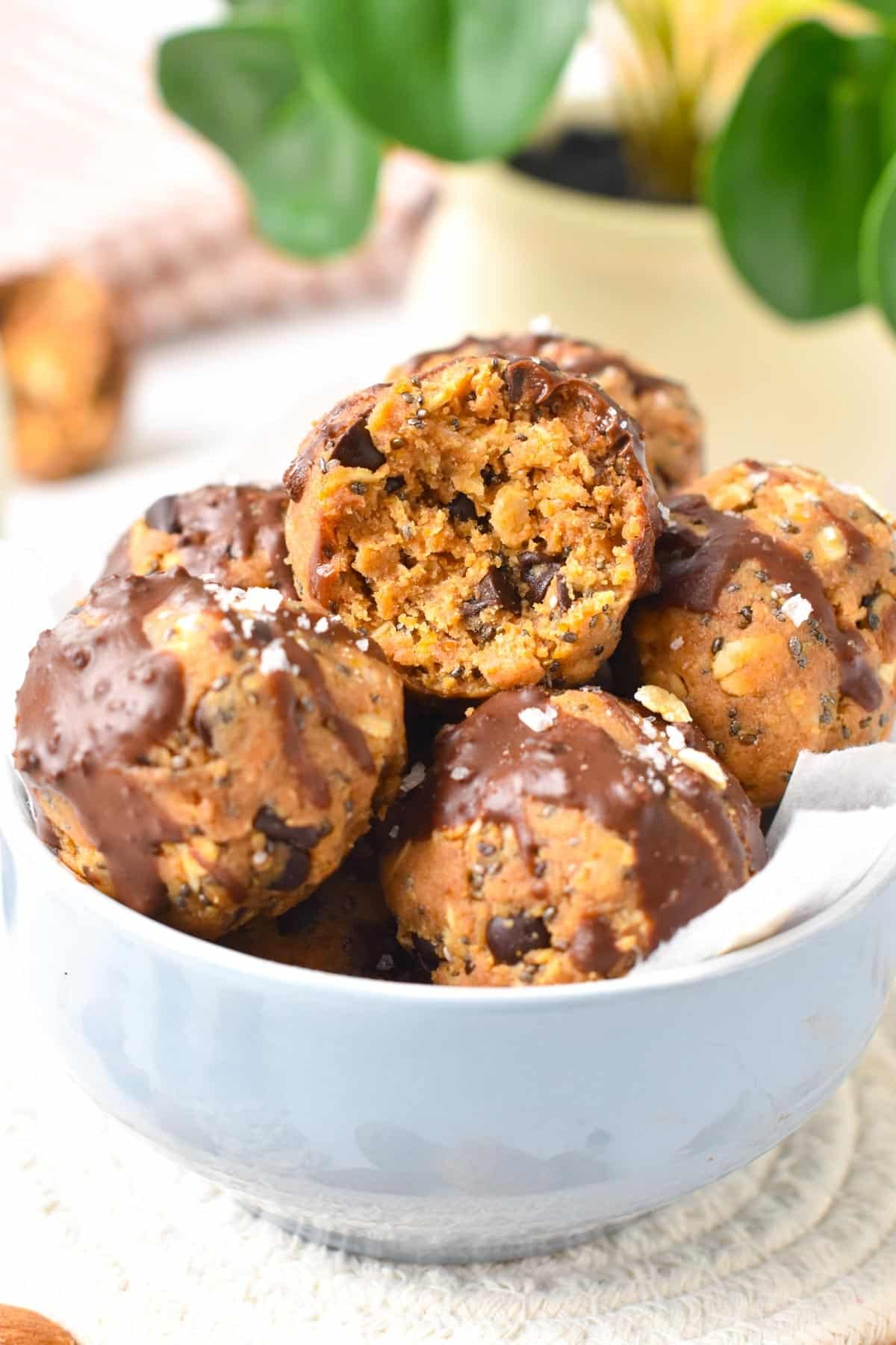 A stack of no-bake peanut butter protein balls filled with chia seeds, oats and flaxseed meal.