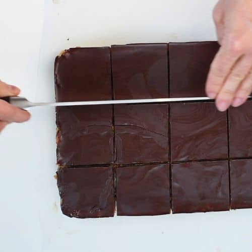 Slicing no-Bake Cookie Dough Bars with a knife.