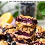 a stack of blueberry jam oatmeal bars with a lemon in the background