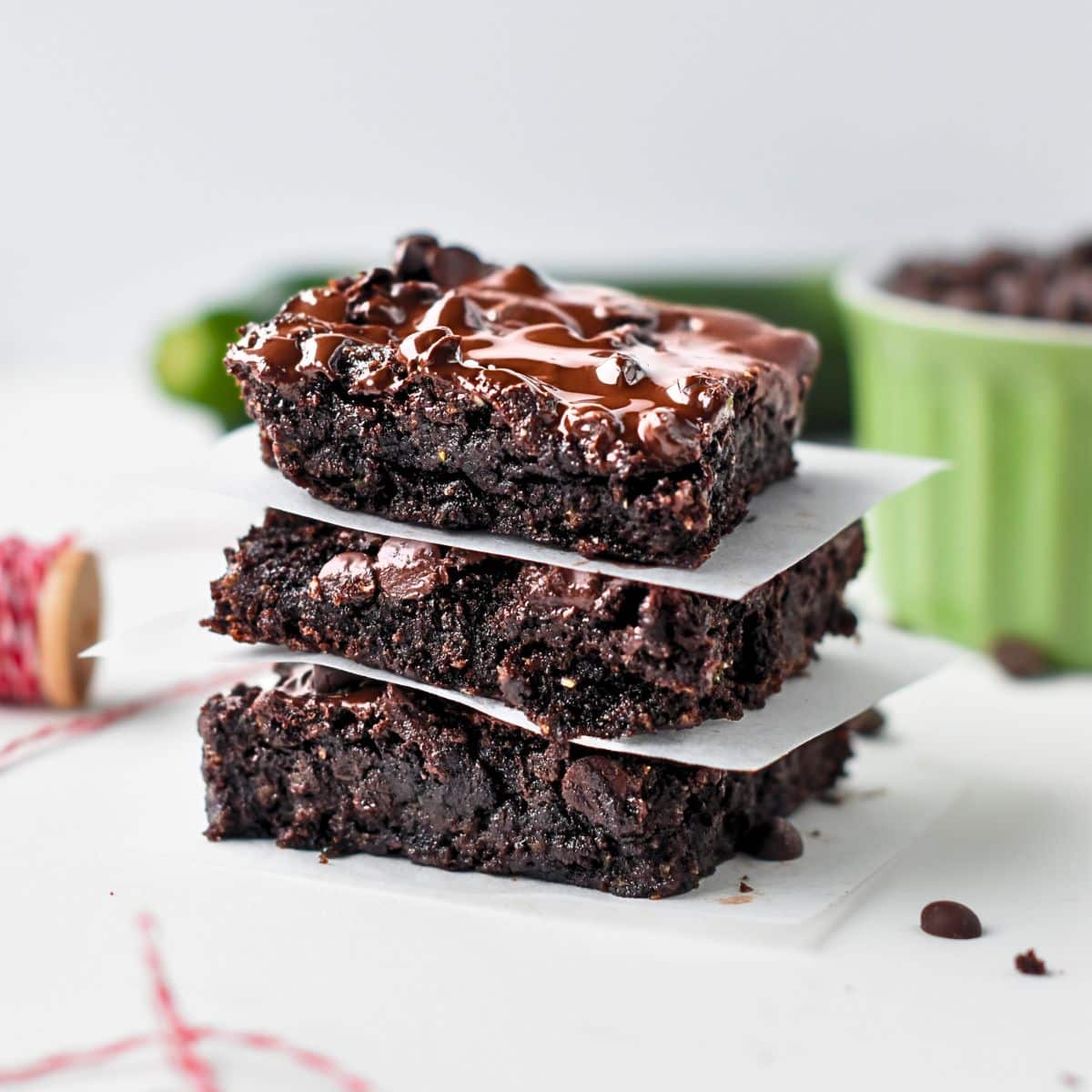 Vegan Zucchini Brownies next to a green ramekin.