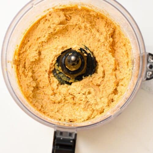 a food processor bowl filled with chickpea cookie dough without chocolate chips