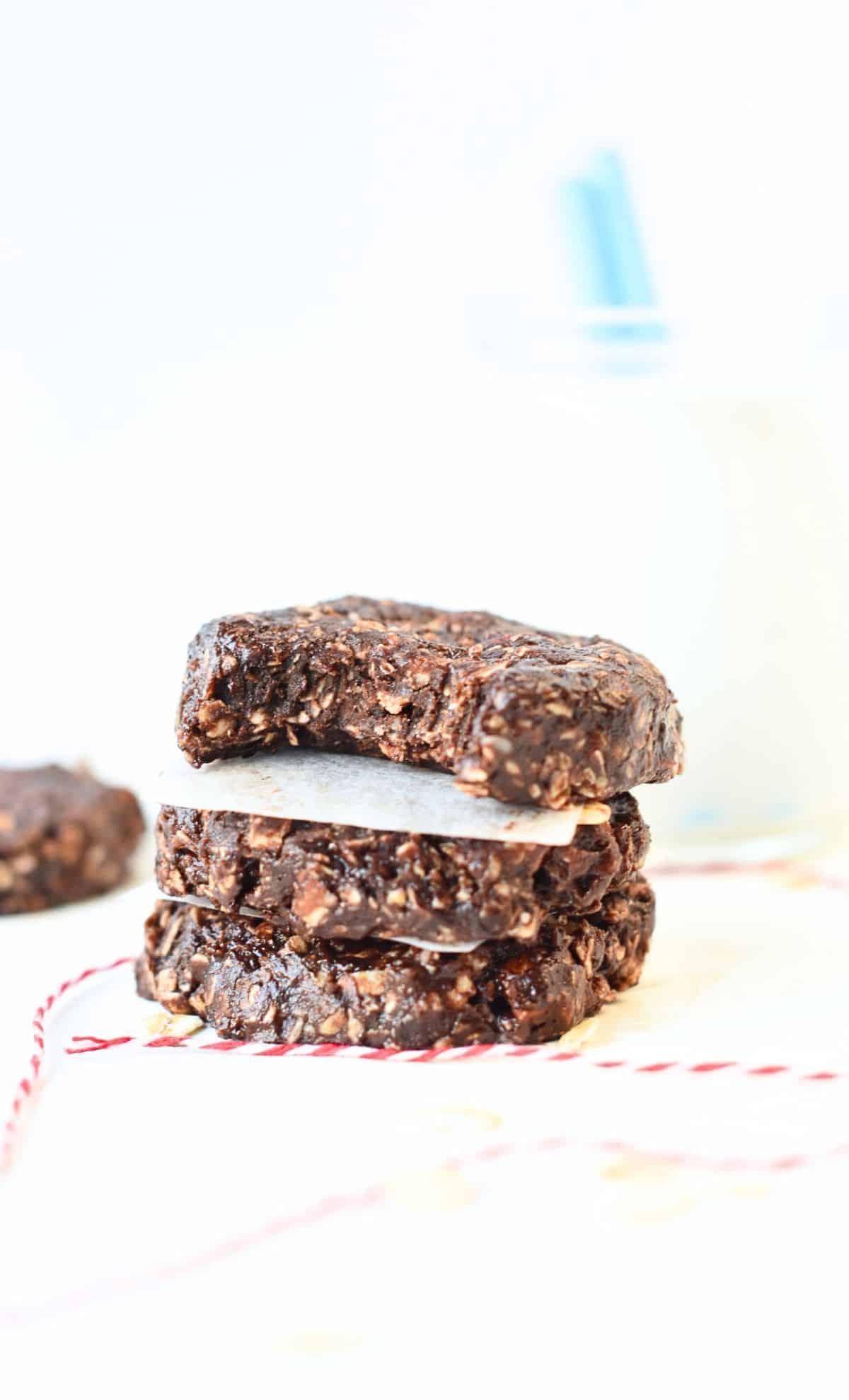 Healthy No-Bake Oatmeal Cookies stacked with the top one half-bitten.