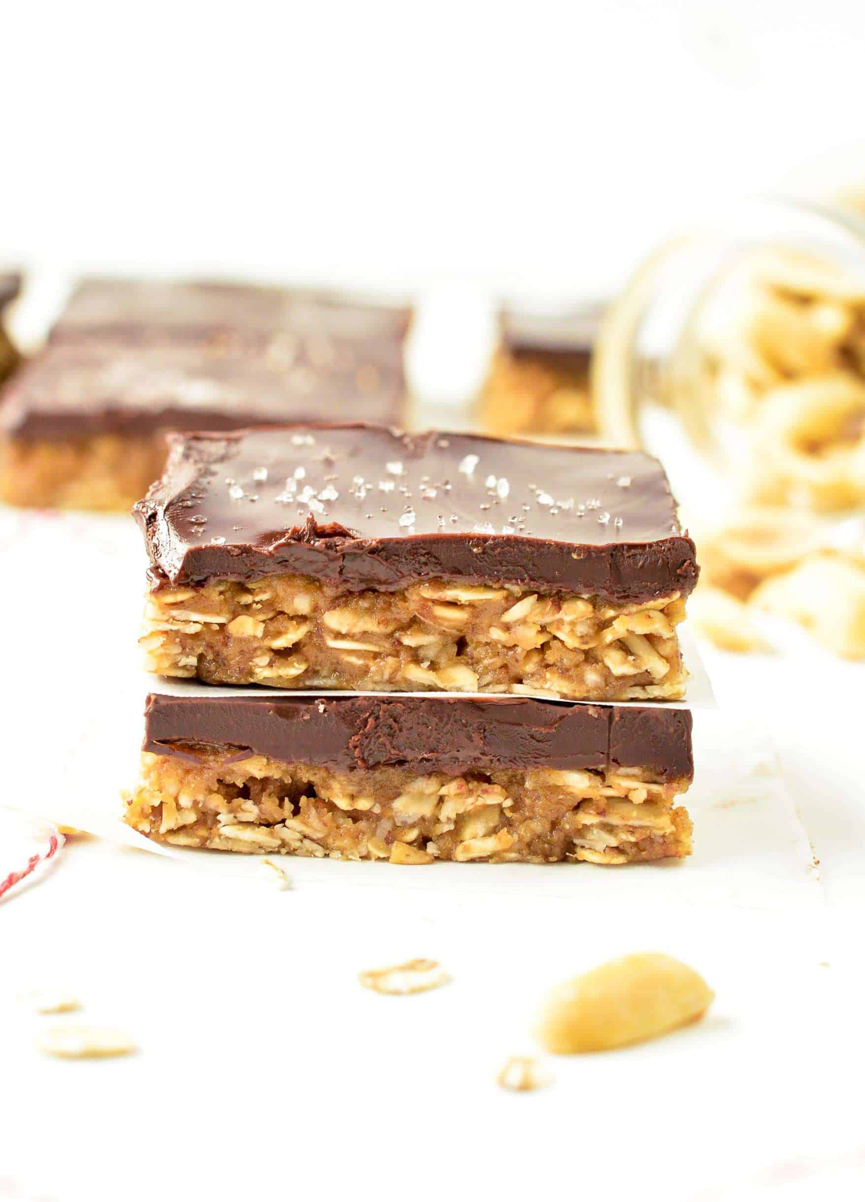 No Bake Peanut Butter Oatmeal Bars stacked on a white table.