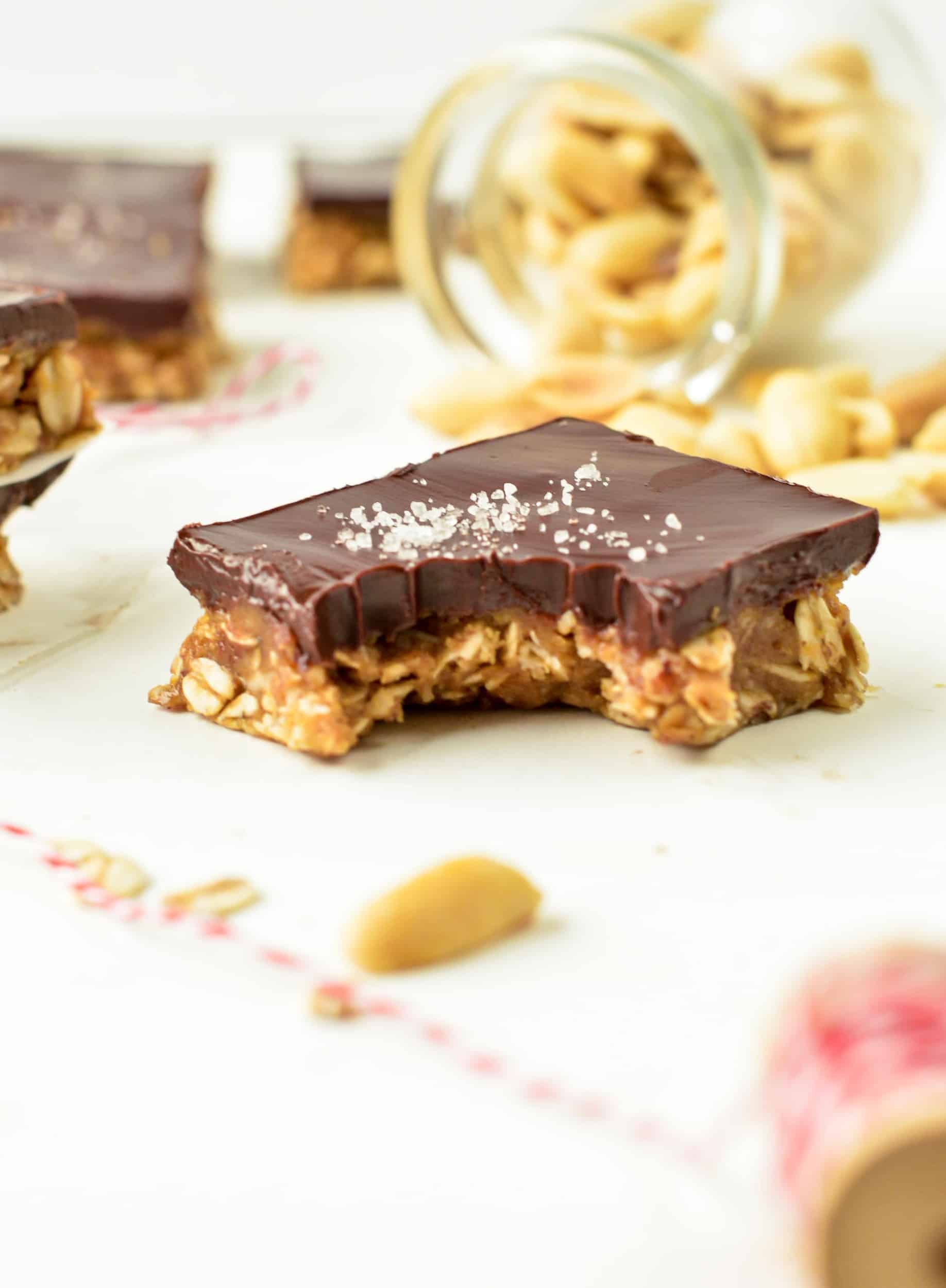 Vegan No Bake Peanut Butter Oatmeal Bars with a square crunched.