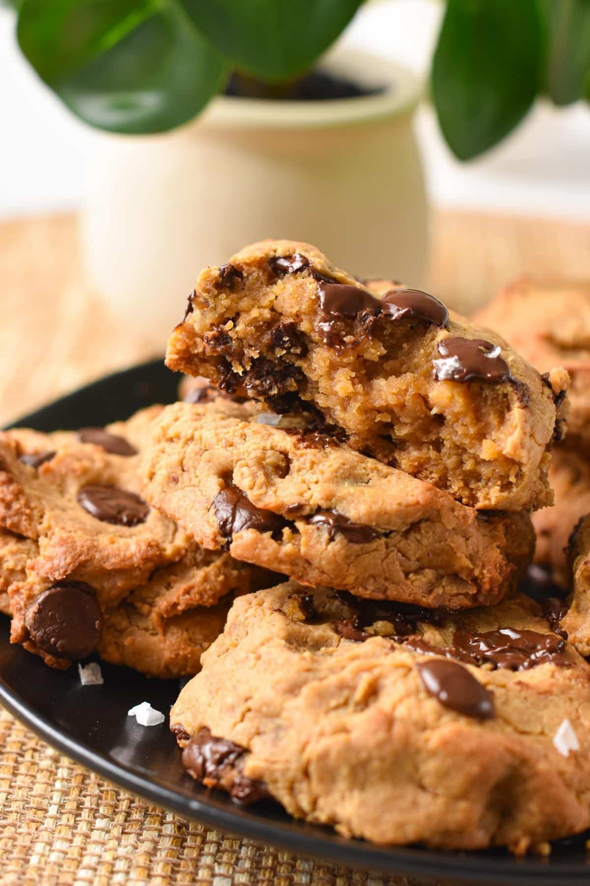 a stack of 2 Chickpea Peanut Butter Cookies with the one on top half broken showing the fudgy texture