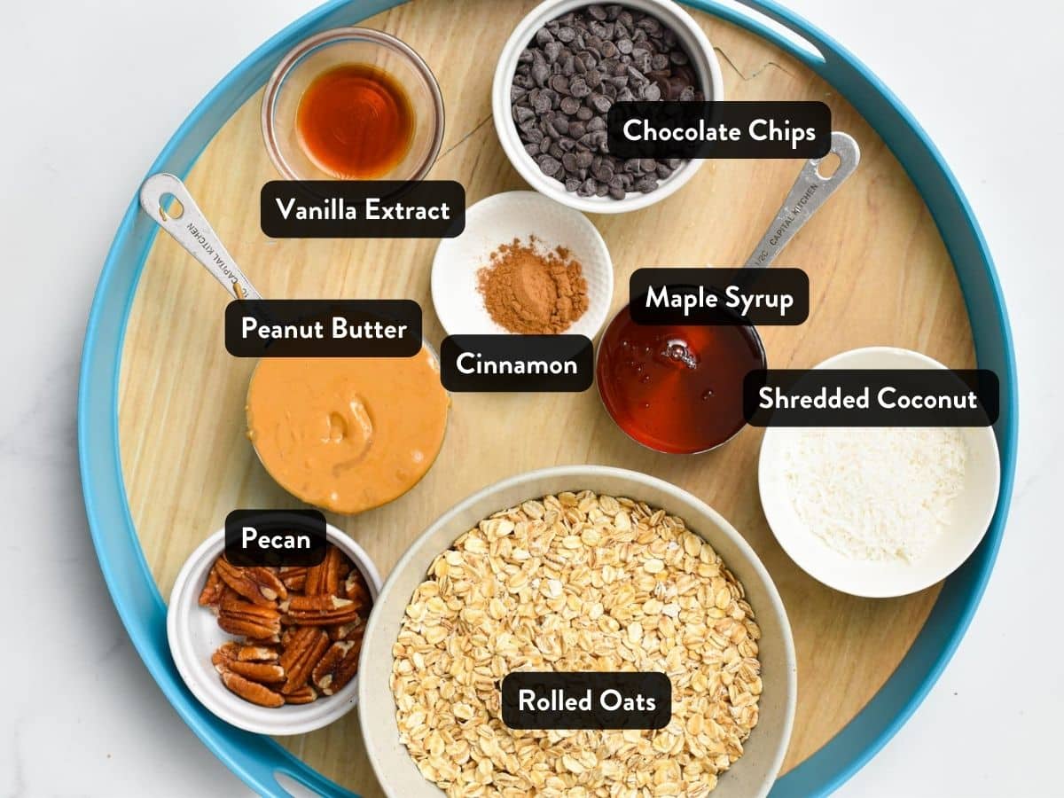 Ingredients for the No-Bake Peanut Butter Oatmeal Balls in various bowls and cups on a serving tray.