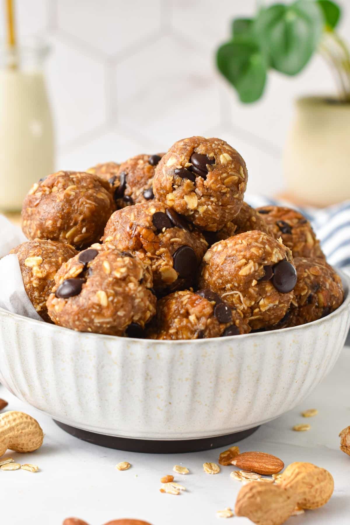 A bowl filled with No Bake Peanut Butter Oatmeal Energy Balls with chocolate chips.