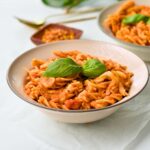 Red Lentil Pasta in a plate with fresh basil