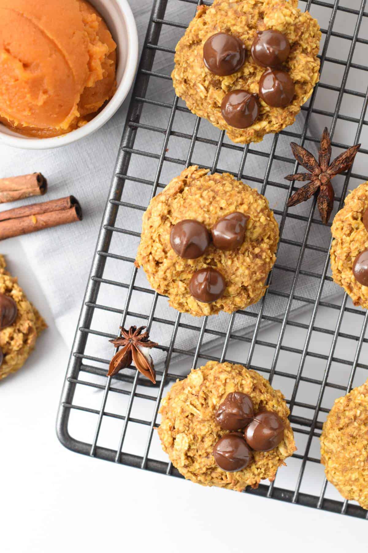 pumpkin oatmeal chocolate chip cookies on a wire rack.