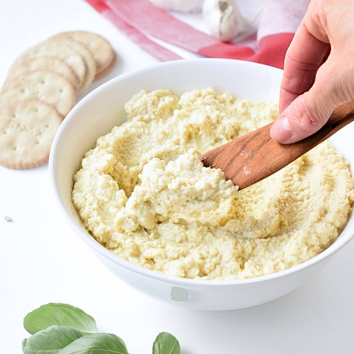 Vegan Almond Ricotta with a wooden spoon.