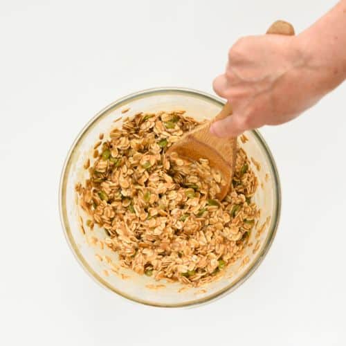 Stirring Healthy No-Bake Flapjacks batter in a bowl.