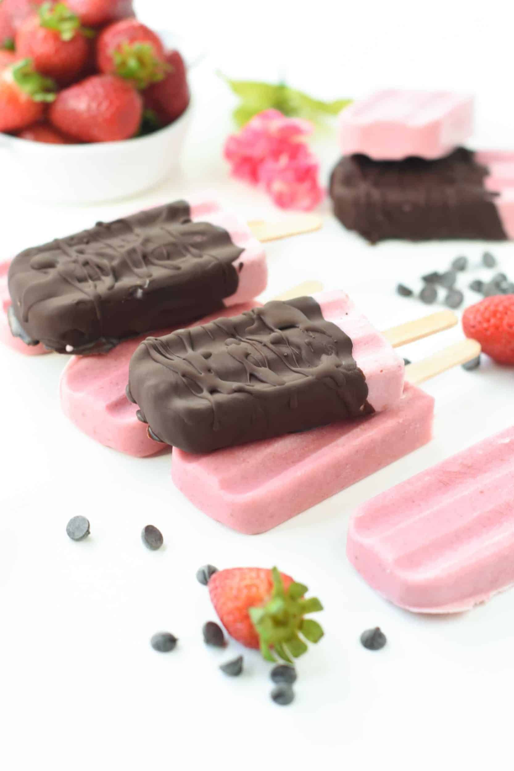 Strawberry popsicles with a chocolate shell.