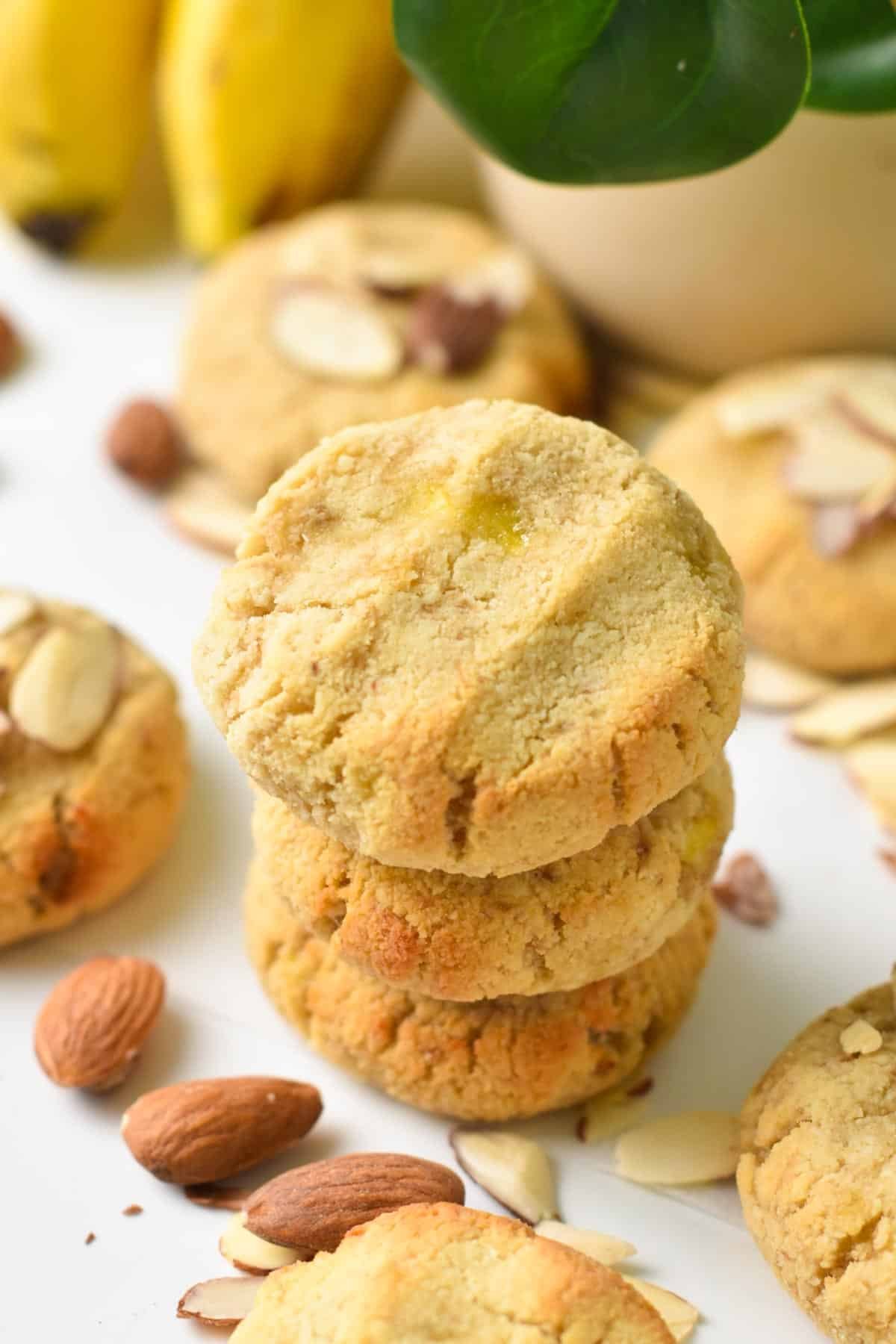 A stack of three Almond Flour Banana Cookies with whole almonds.