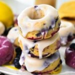 a stack of three lemon glazed blueberry donuts