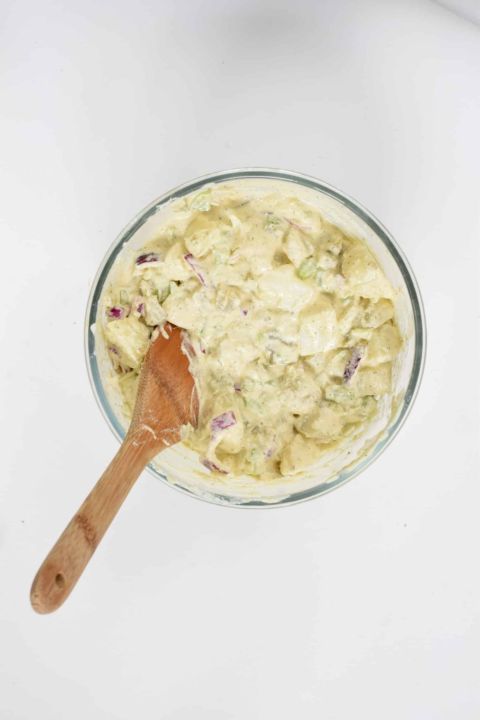 Vegan Potato Salad stirred in a mixing bowl.