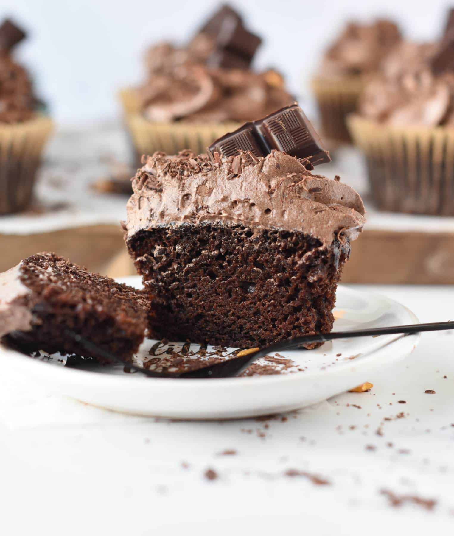 Vegan Chocolate Cupcakes sliced in half showing the soft and moist crumb.