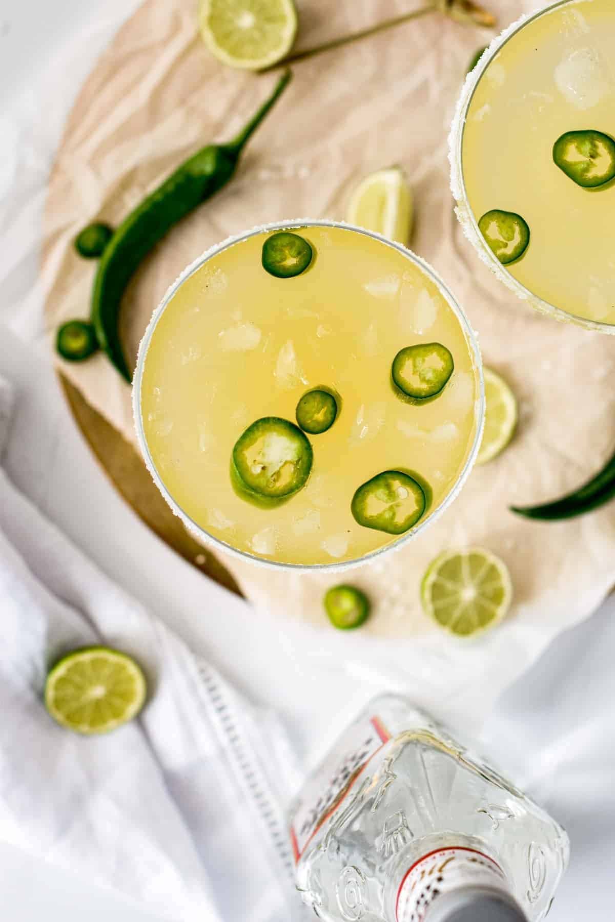 Spicy Skinny Margarita in two glasses with jalapeno slices.