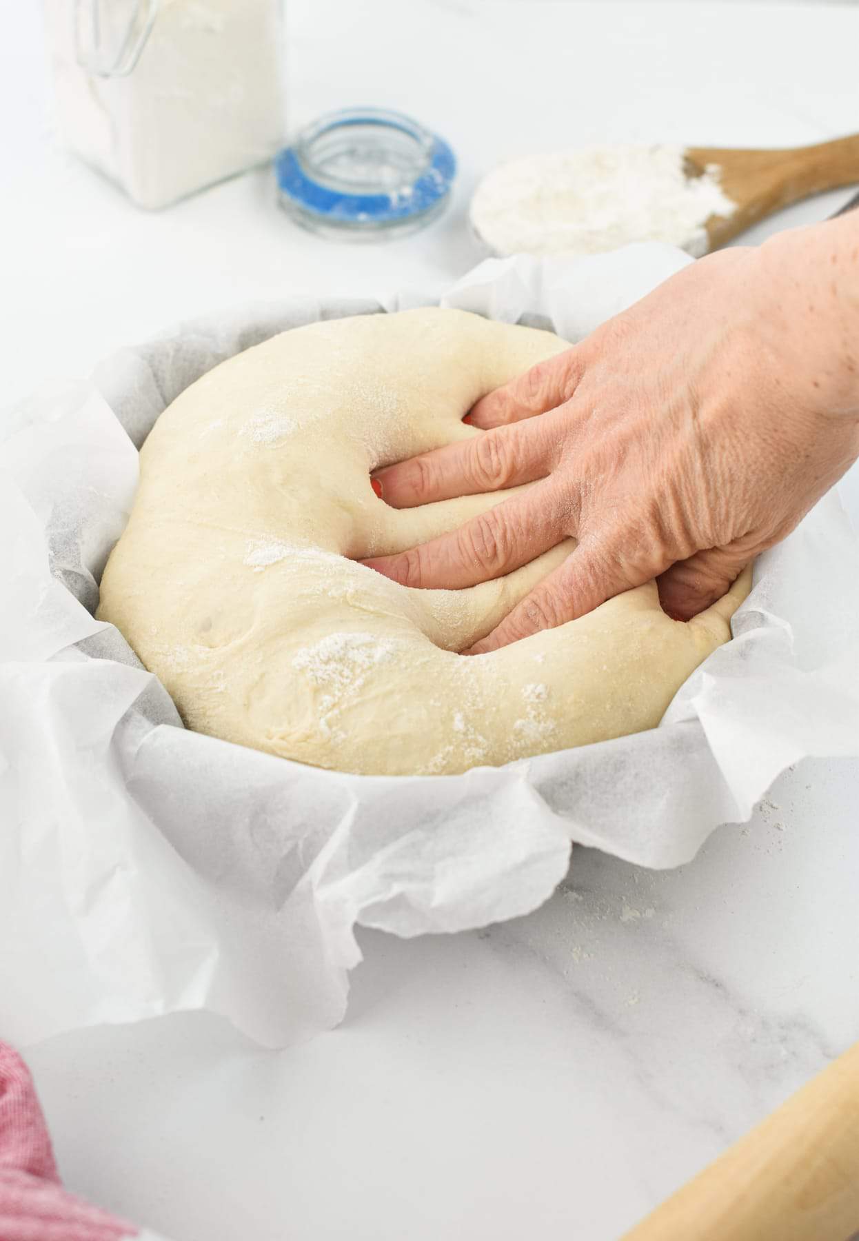 Spelt Pizza Dough pressed in a bowl.