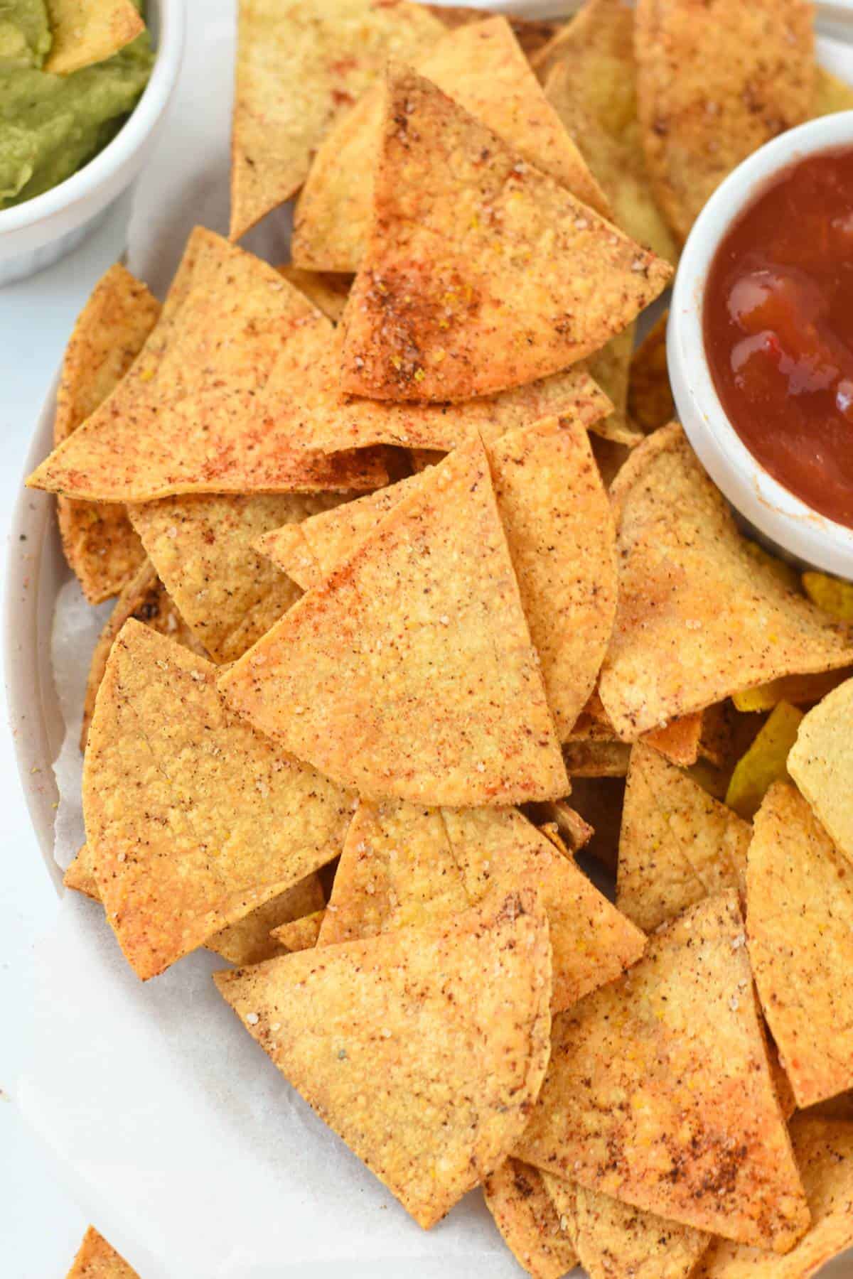 Air Fryer Tortilla Chips on a plate with a small cup of salsa.
