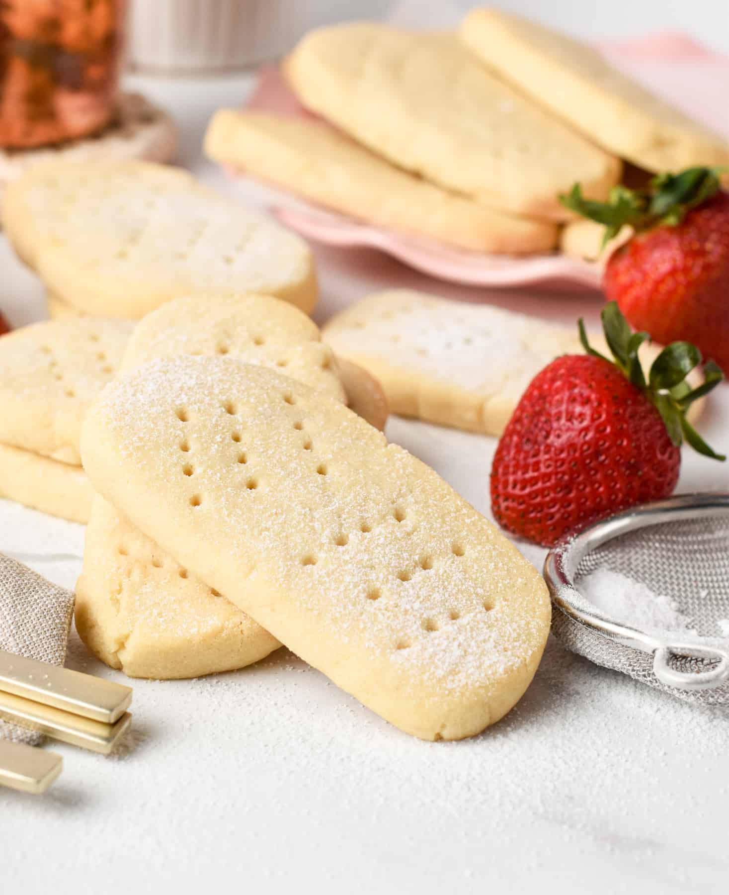 A few Vegan Shortbread Cookies next to fresh strawberries.