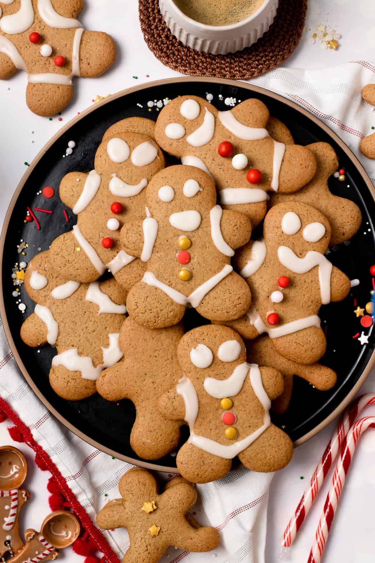 Healthy Vegan Gingerbread Man on a large black plate, decorated with vegan icing.