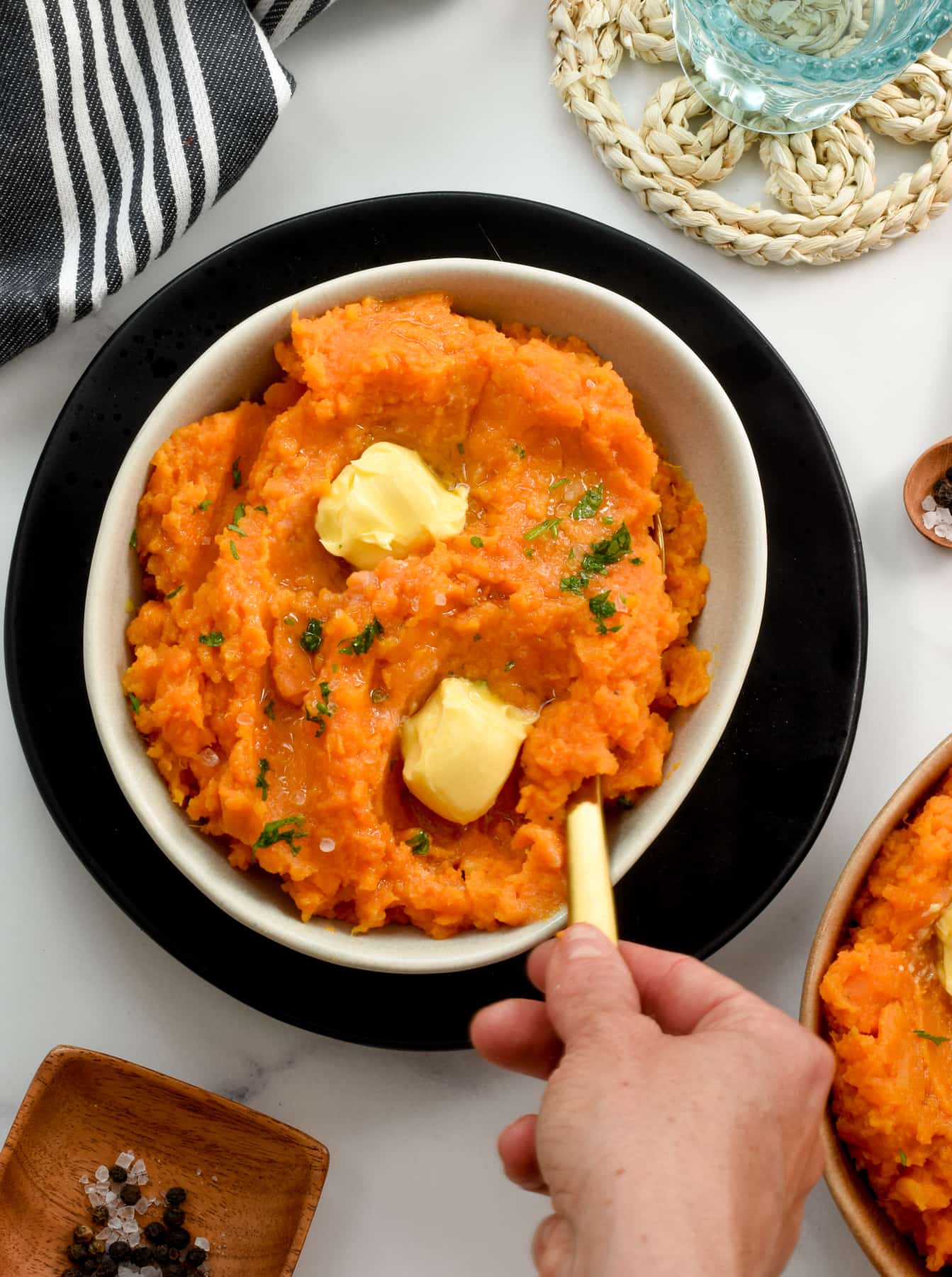 Mashed Sweet Potatoes in a bowl with a golden spoon.
