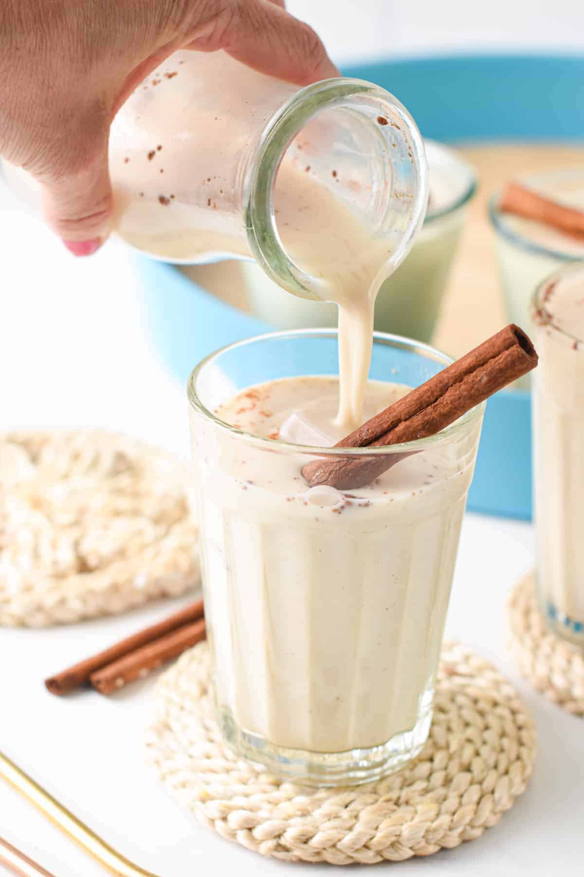 Pouring Vegan Horchata into a glass.