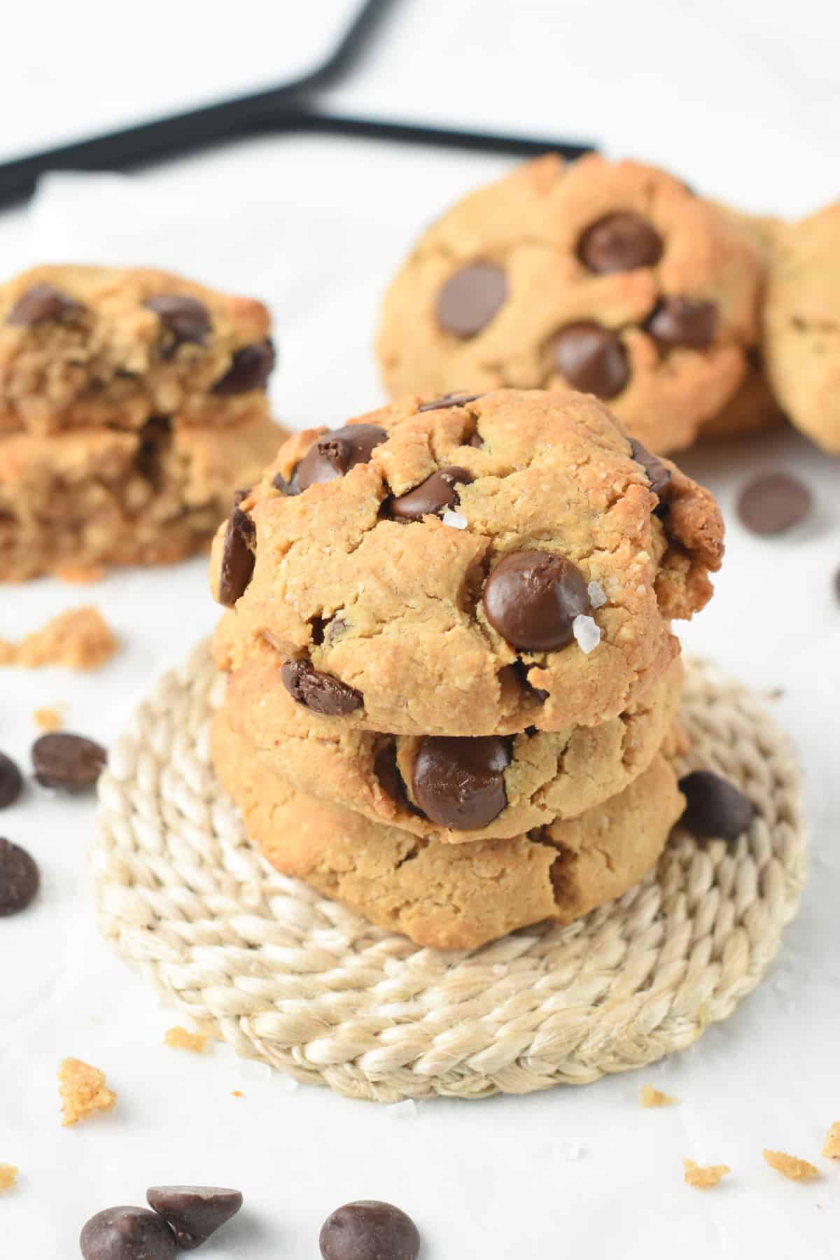 Protein Cookies cookies stacked on a natural coaster.