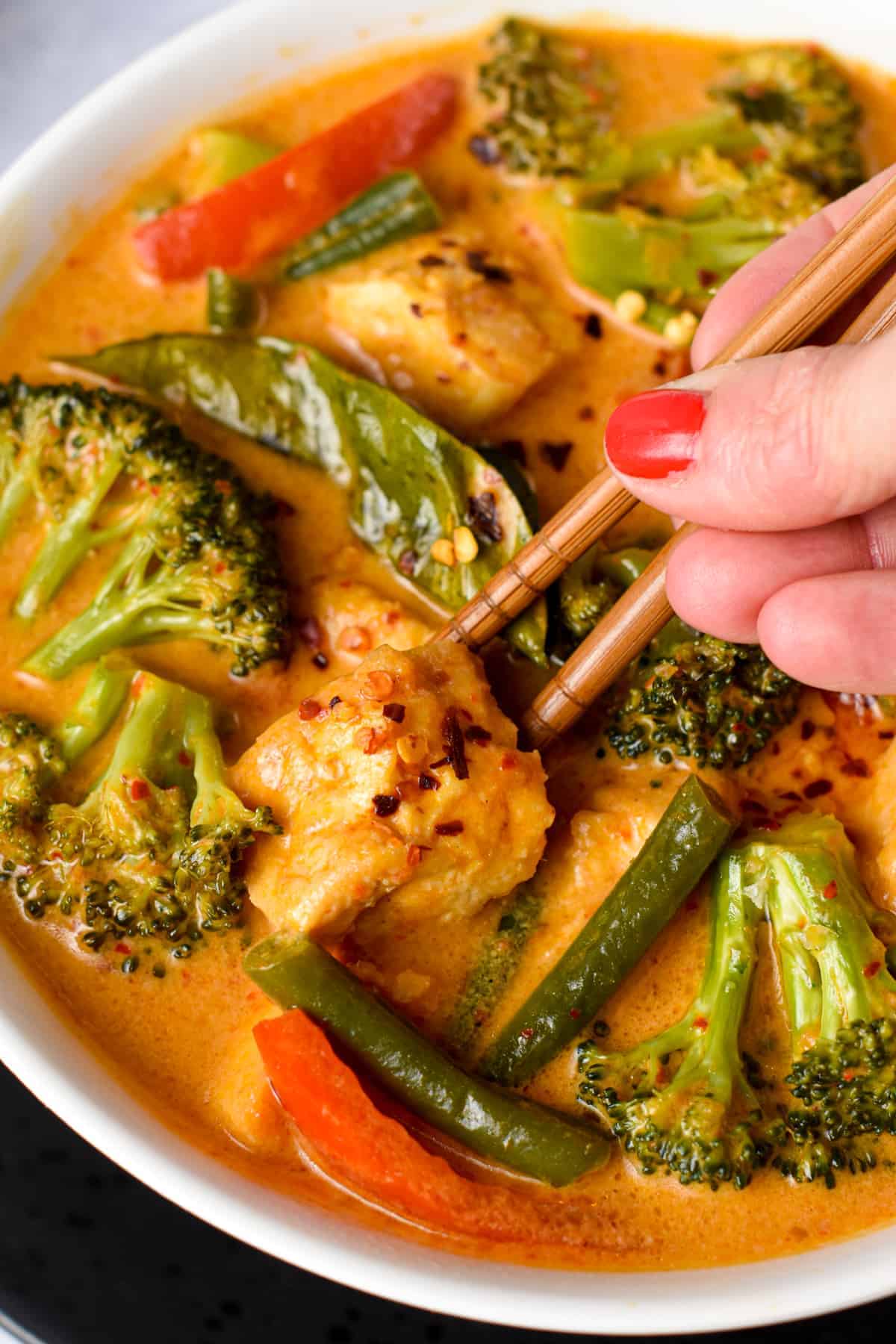 Tofu Red Curry served on a bowl with chopsticks.