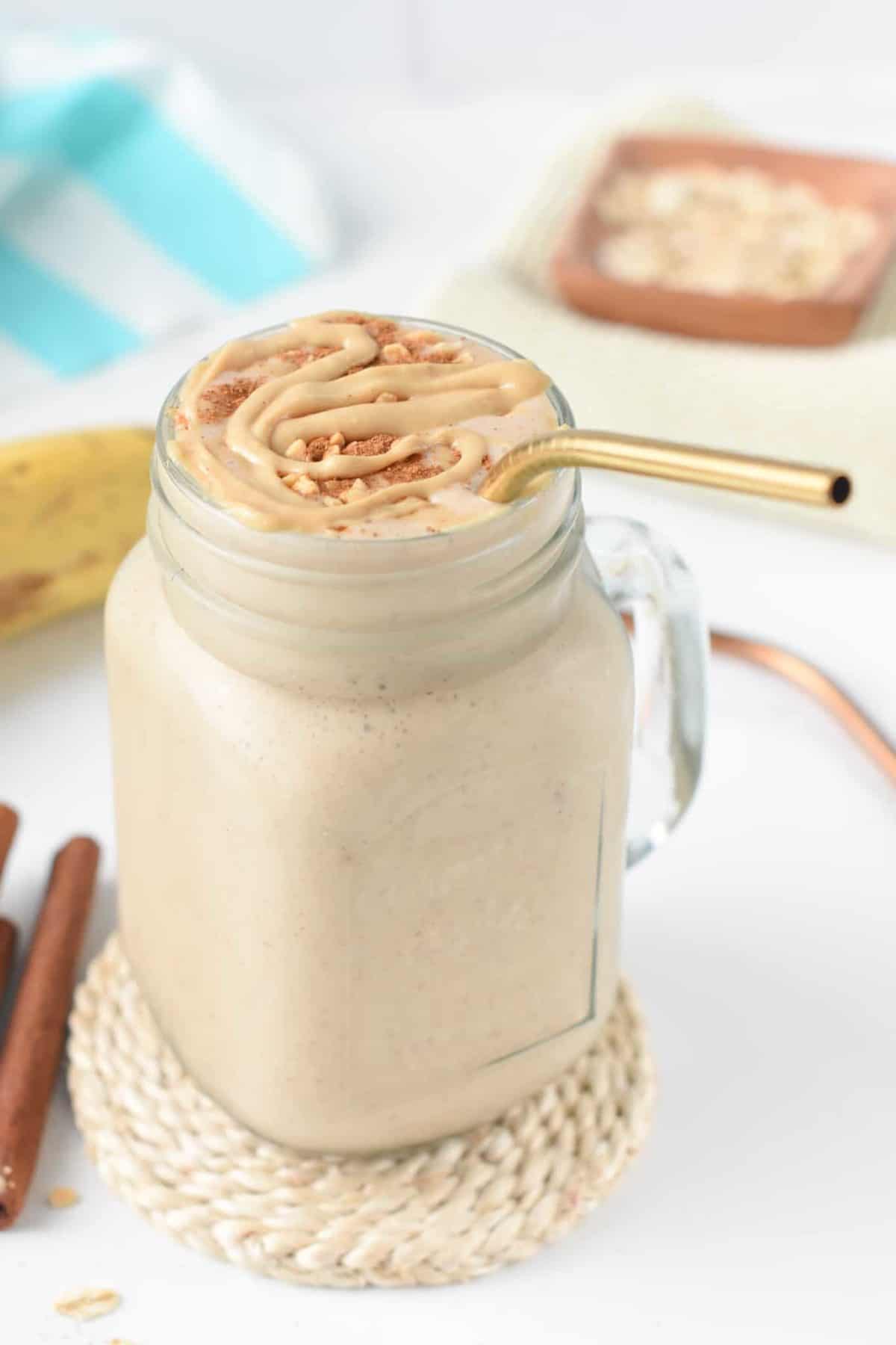 Cinnamon Roll Protein Shake with a golden straw.