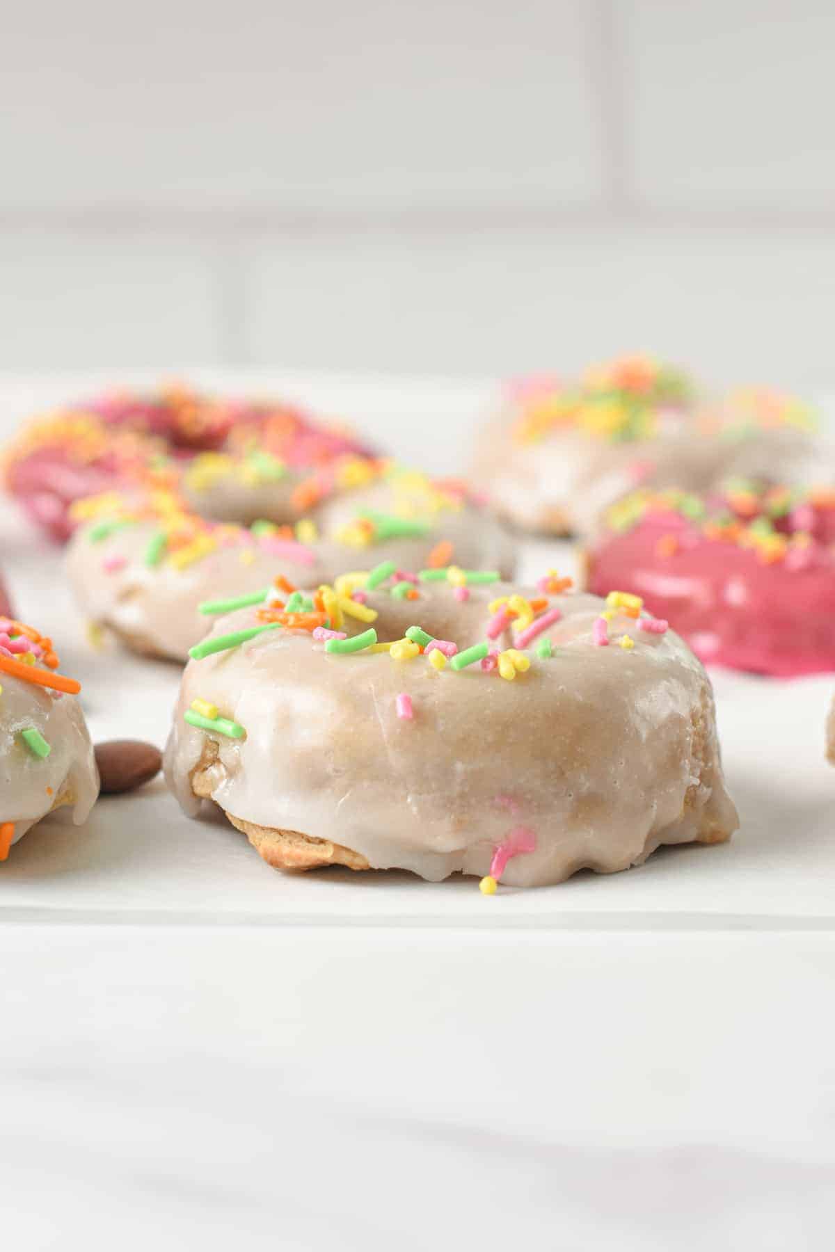 Protein Donuts Recipe decorated with vegan glazing and sprinkles.