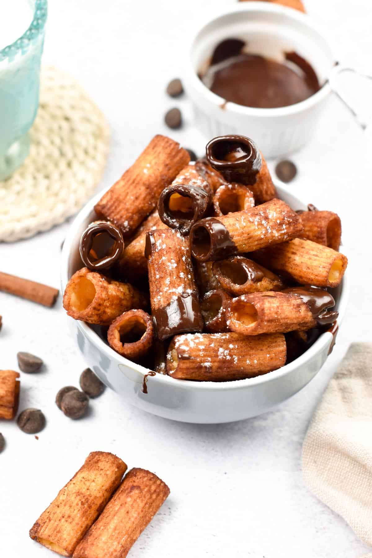 Air Fryer Pasta dipped in chocolate, in a white bowl.