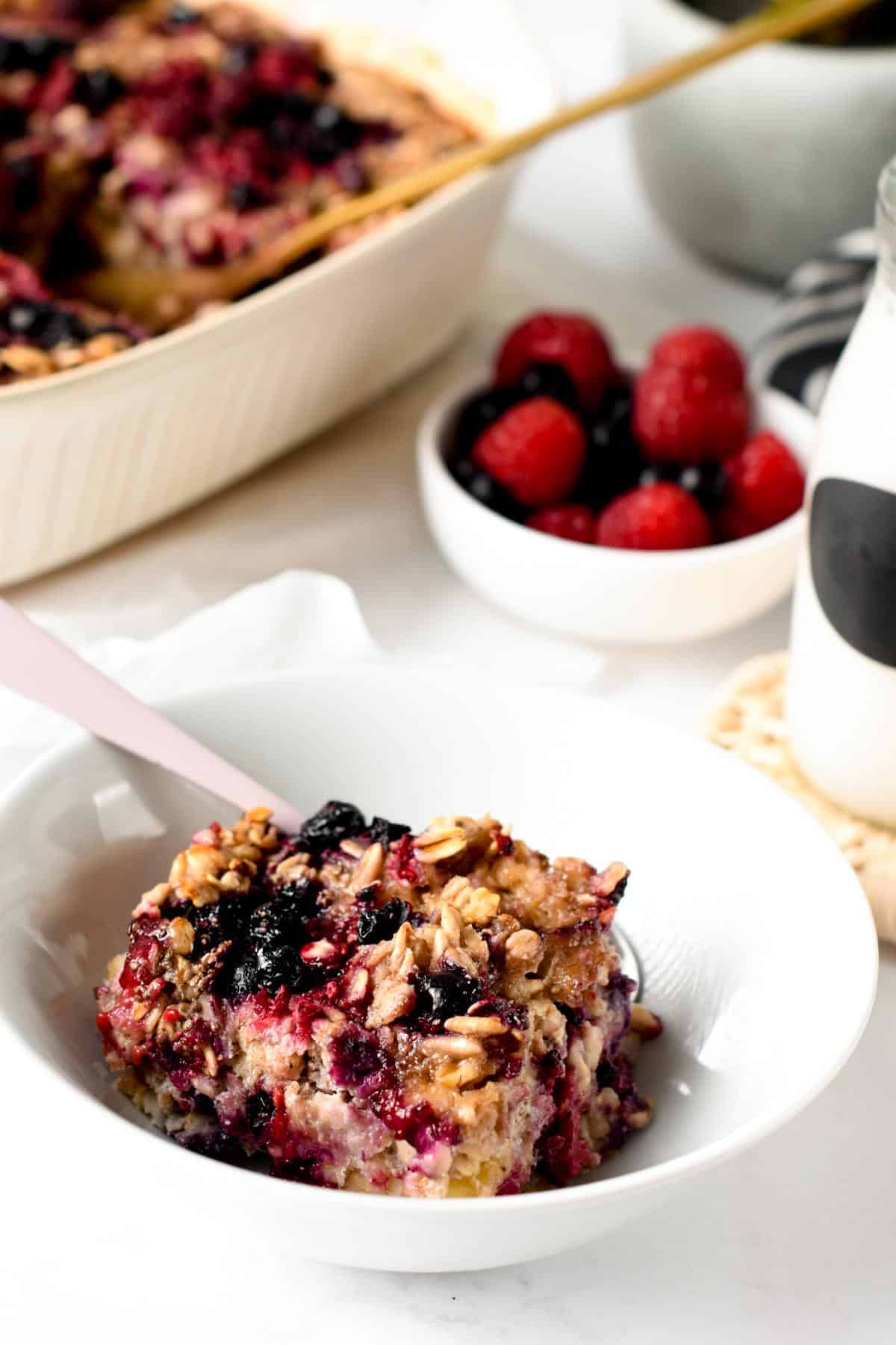 Vegan Baked Oatmeal portion in a bowl with a spoon.