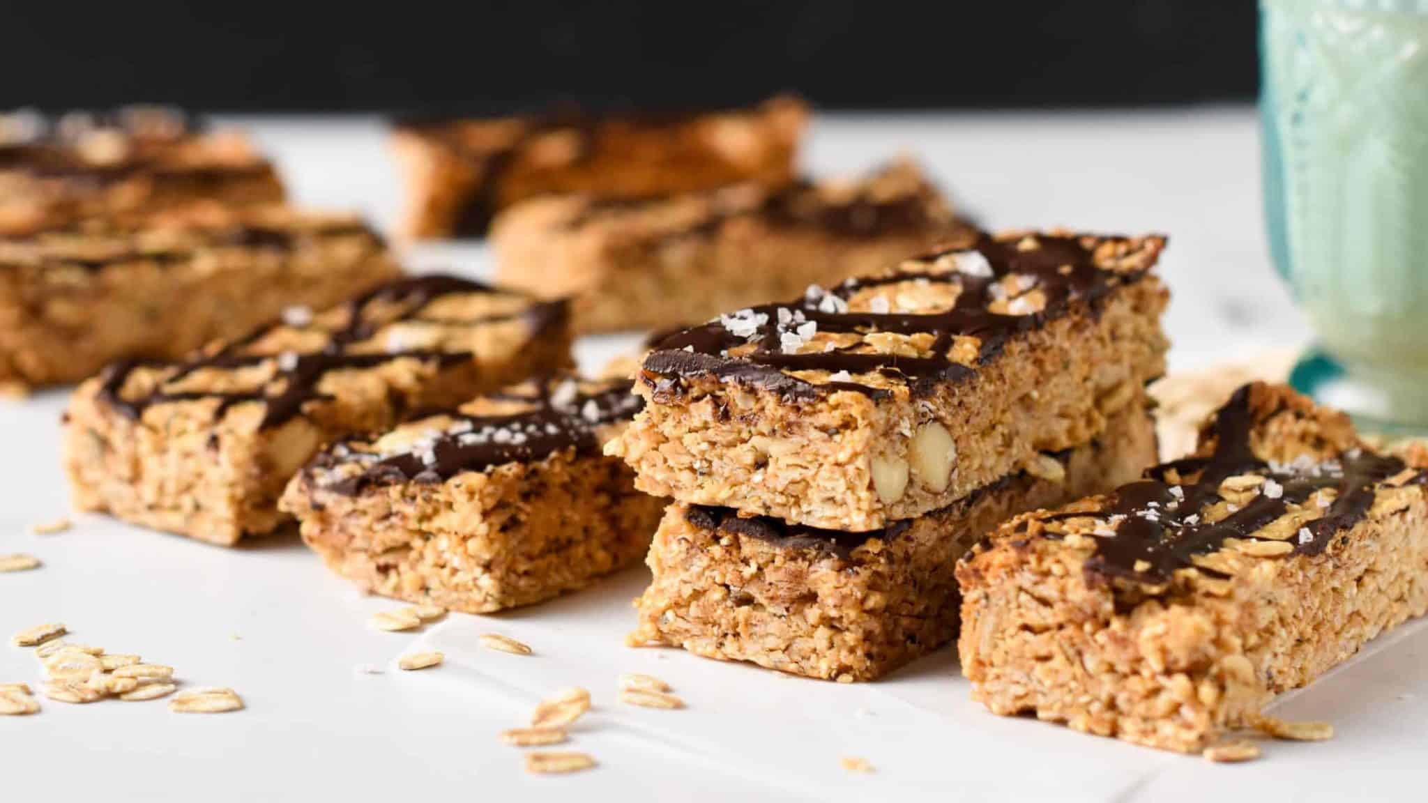 Peanut Butter Granola Bars lined on a table and stacked.