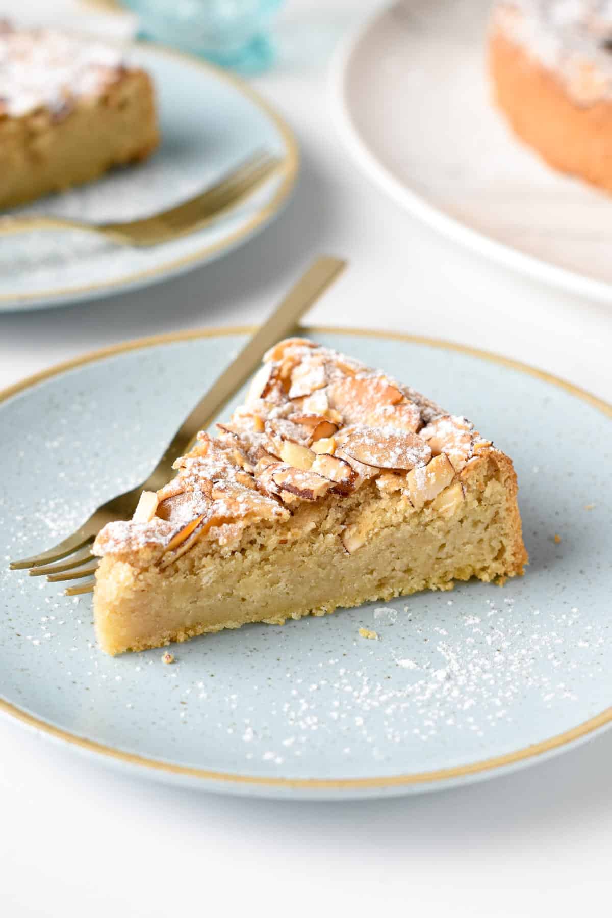 Almond Flour Cake slice on a plate with a golden fork.