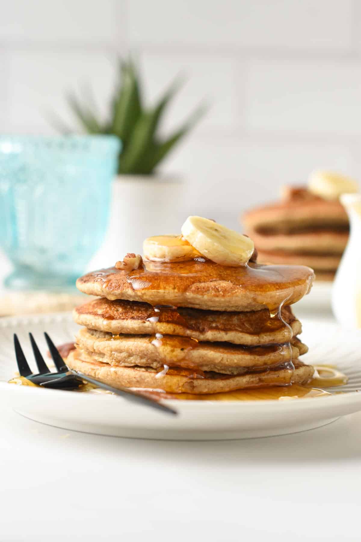 Banana Oatmeal Pancakes stacked on a plate.