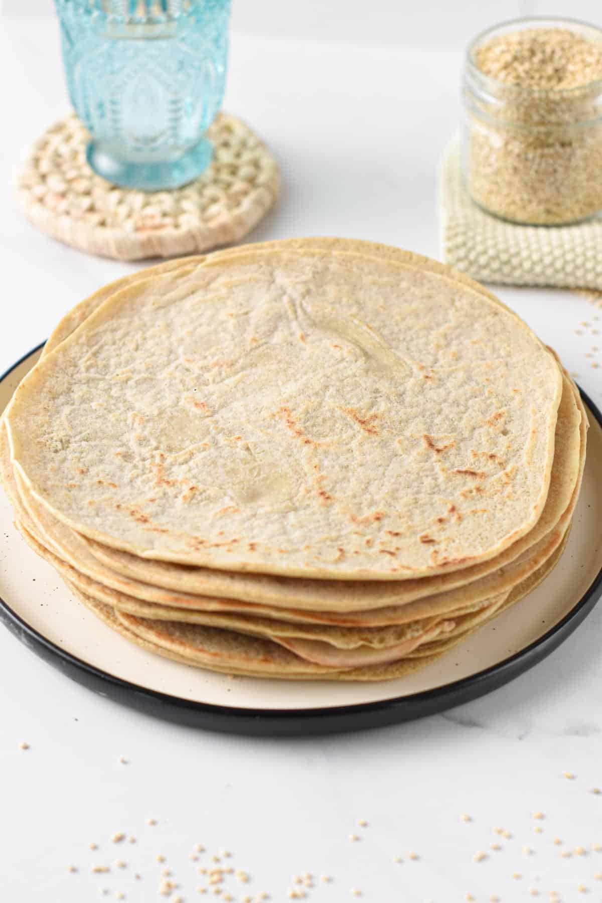 Quinoa Tortillas stacked on a plate.