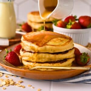 Vegan pancake stack with maple syrup dripping