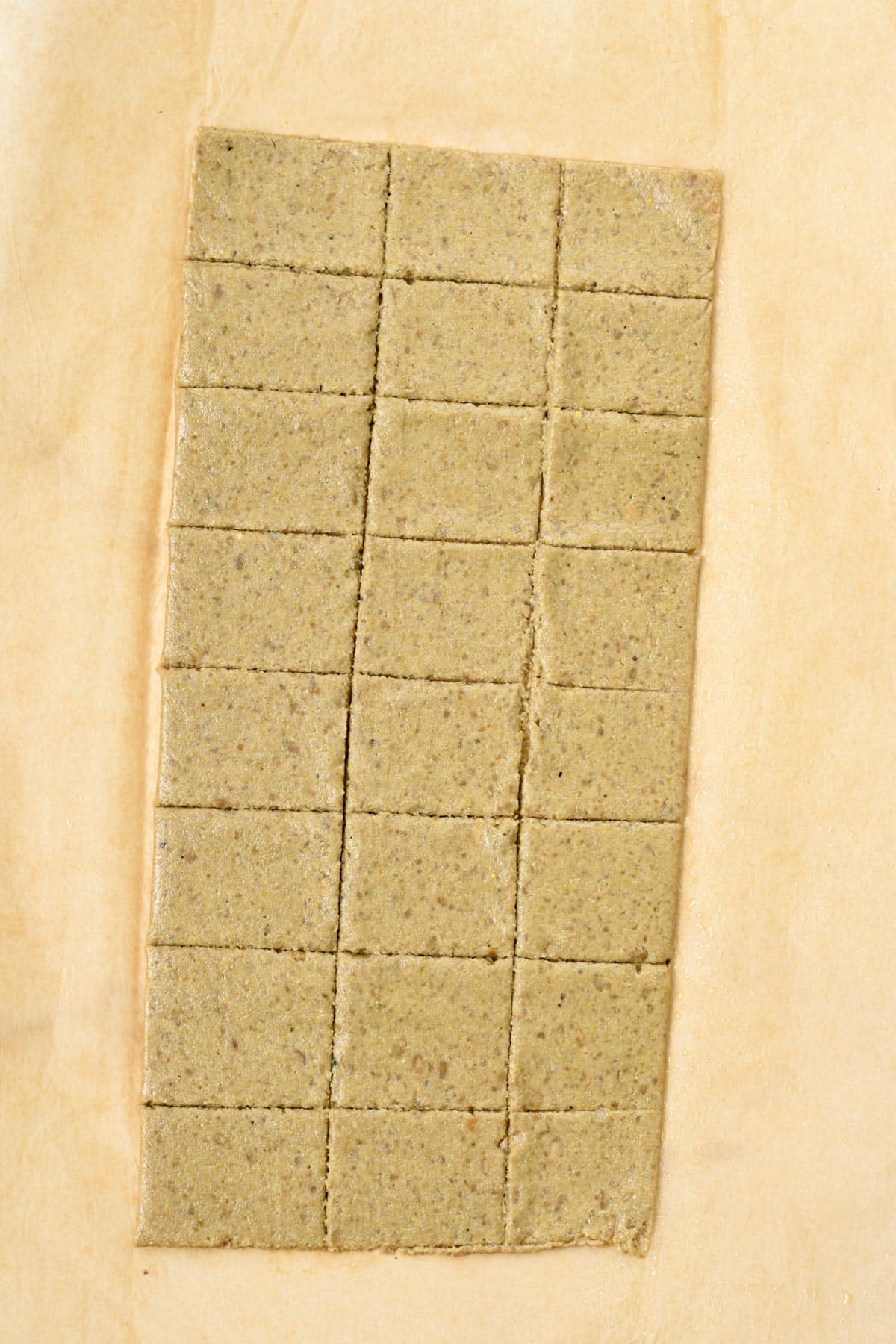 Sunflower Seed Crackers batter flattened and sliced on a backing sheet.