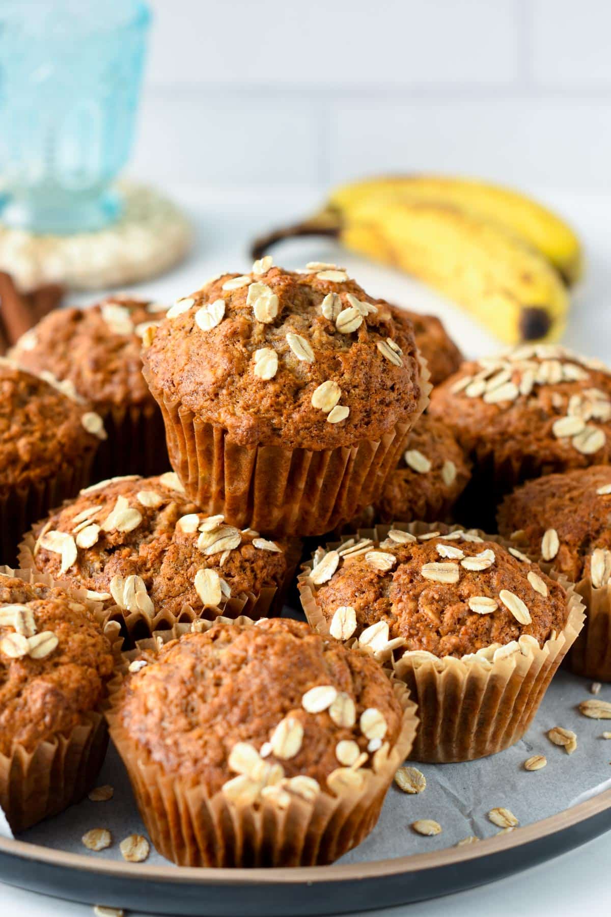 Healthy Banana Oatmeal Muffins stacked on a black plate.