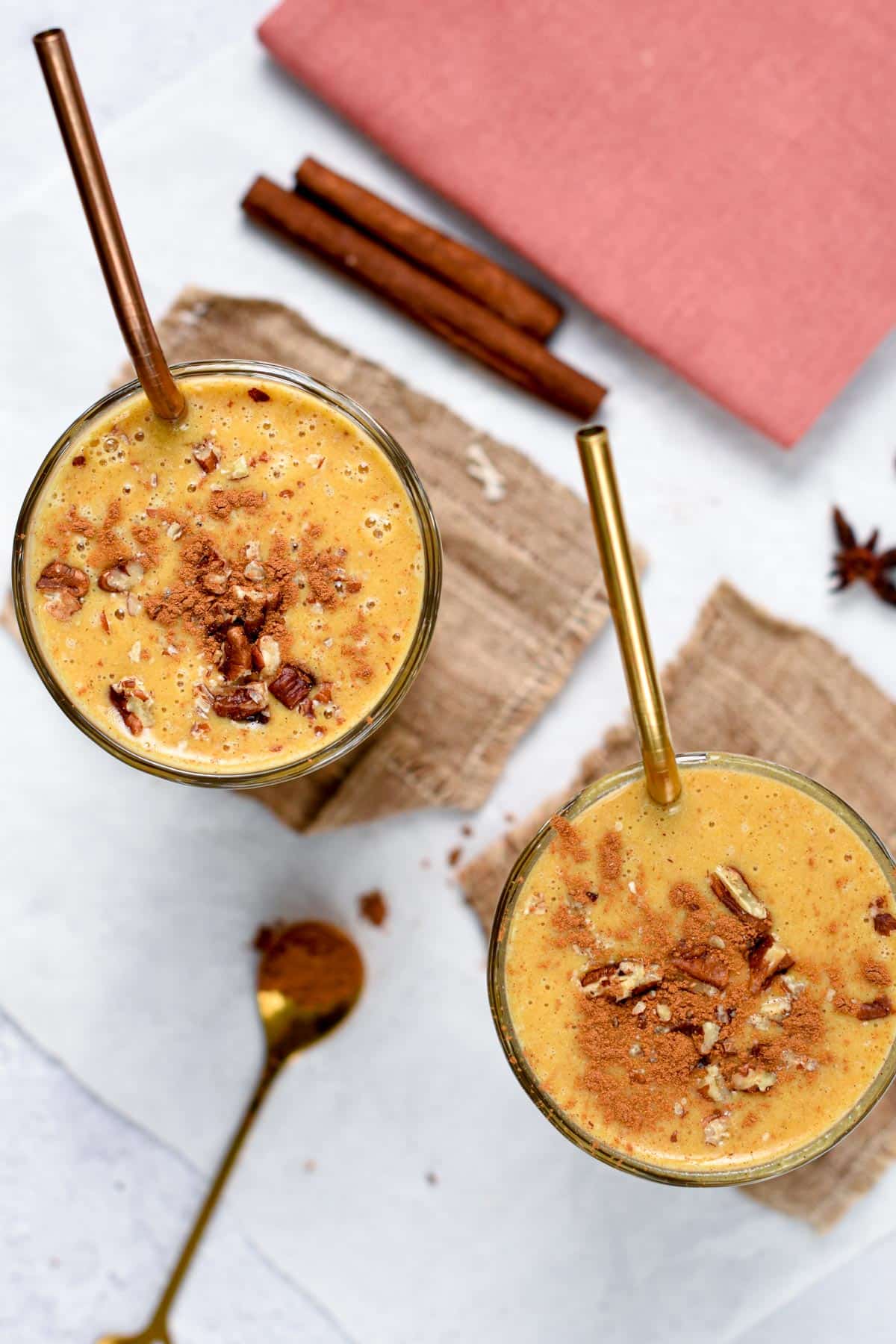 Pumpkin Pie Spice Smoothie in two different glasses viewed from the top.
