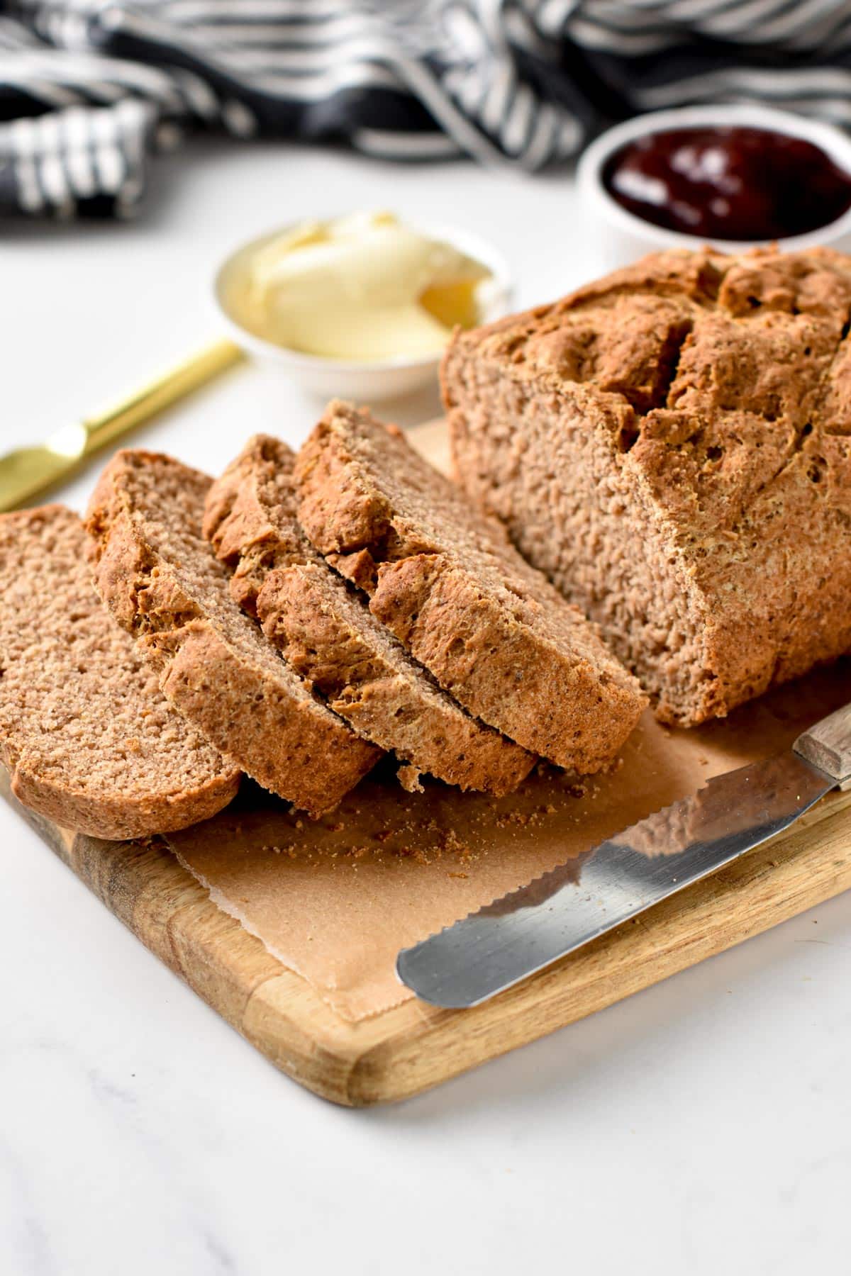 Vegan Gluten Free Bread sliced on a wooden chopping board.