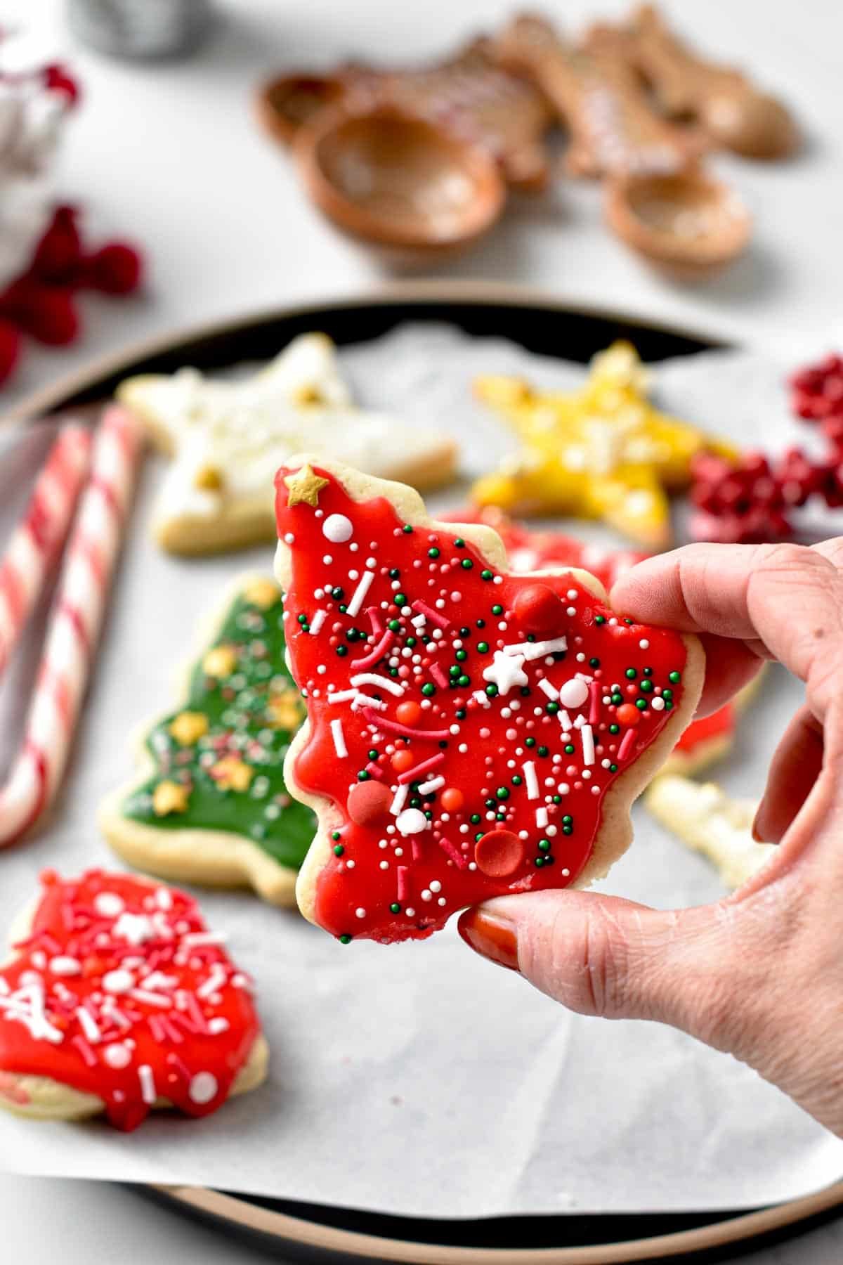Showing a Vegan Sugar Cookies decorated with red icing and sprinkles.