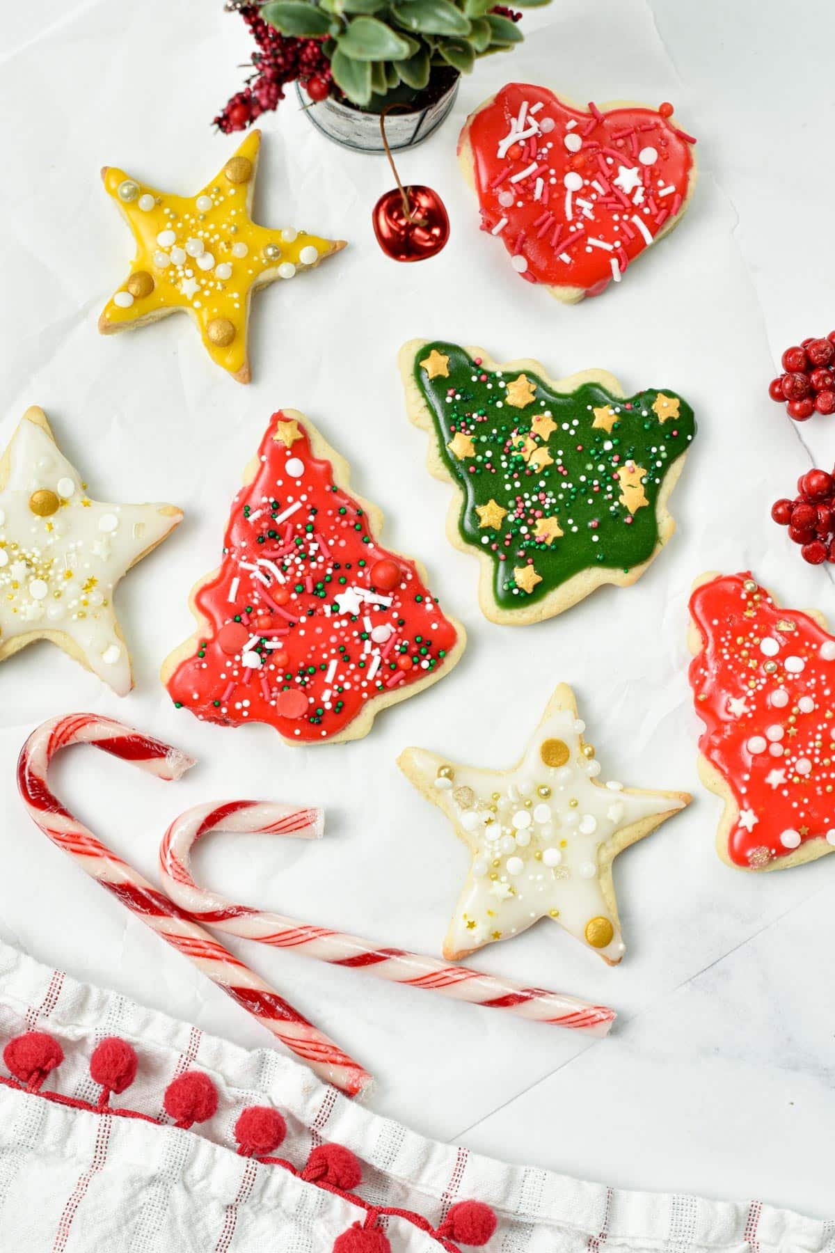 Vegan Sugar Cookies cut with Christmas cookie cutter and decorated with Christmas food coloring.